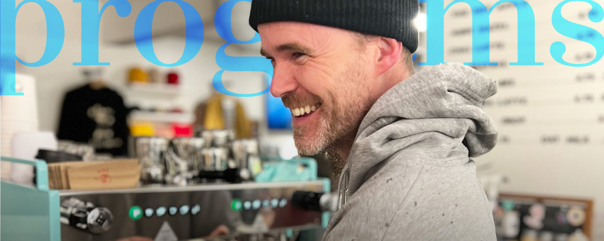 coffee shop owner behind coffee machine